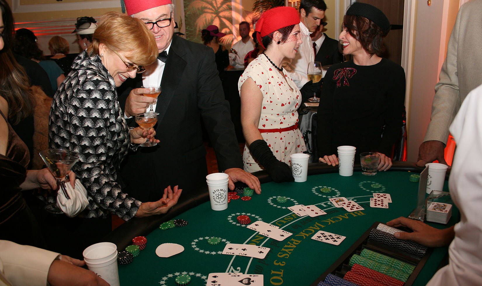 Guests at a card game table at a Casablanca themed Halloween party at Jordan Winery