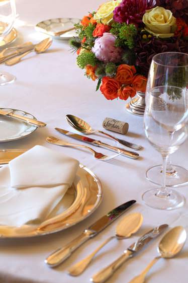 dining table setting with a colorful floral centerpiece