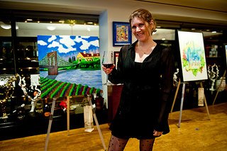 Jen Ferguson posing next to her entry piece "Wine City" which was awarded second runner up at 4 on 4 New York