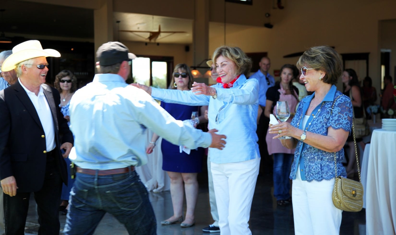 Ms. Jordan greeting John Jordan with a hug at the hangar during the Jordan Estate Rewards Barbecue