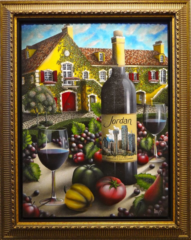 A piece of art from the 4 on 4 Jordan Winery art competition. In a gold frame is the still life digital painting of 2 glasses of Jordan's 2012 Cabernet Sauvignon next to the bottle. Surrounding them are grape clusters, bell peppers, and tomatoes. In the background, Jordan Winery's yellow walls are covered with ivy. The wine label displays a cityscape.