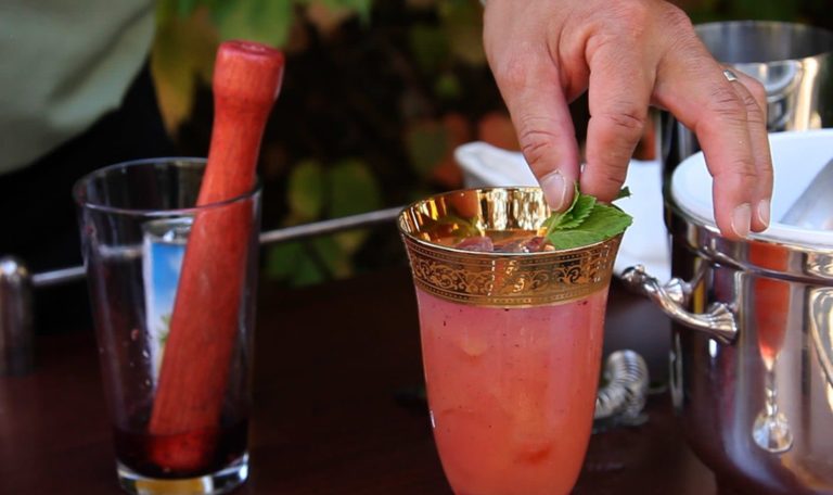 hand garnishing a cocktail at a gladiator themed Halloween party at Jordan Winery