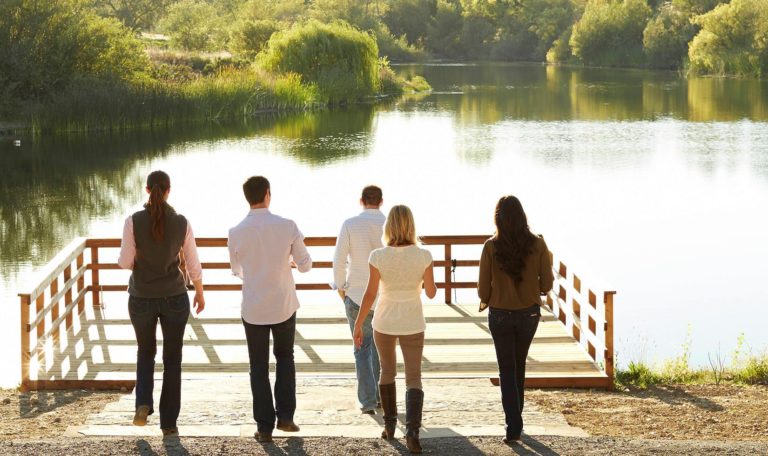 Guests enjoying a dock at the bass lake on the Jordan Winery Estate Tour and tasting