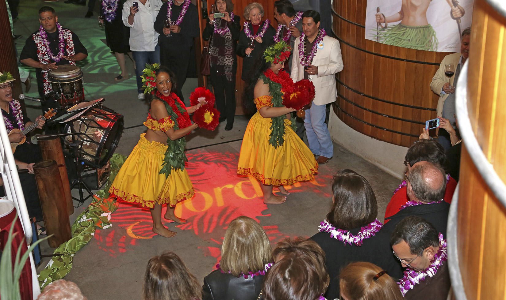 dancers performing at a Spirit of Hawaii themed Christmas at Jordan event in the largo oak tank room at Jordan Winery