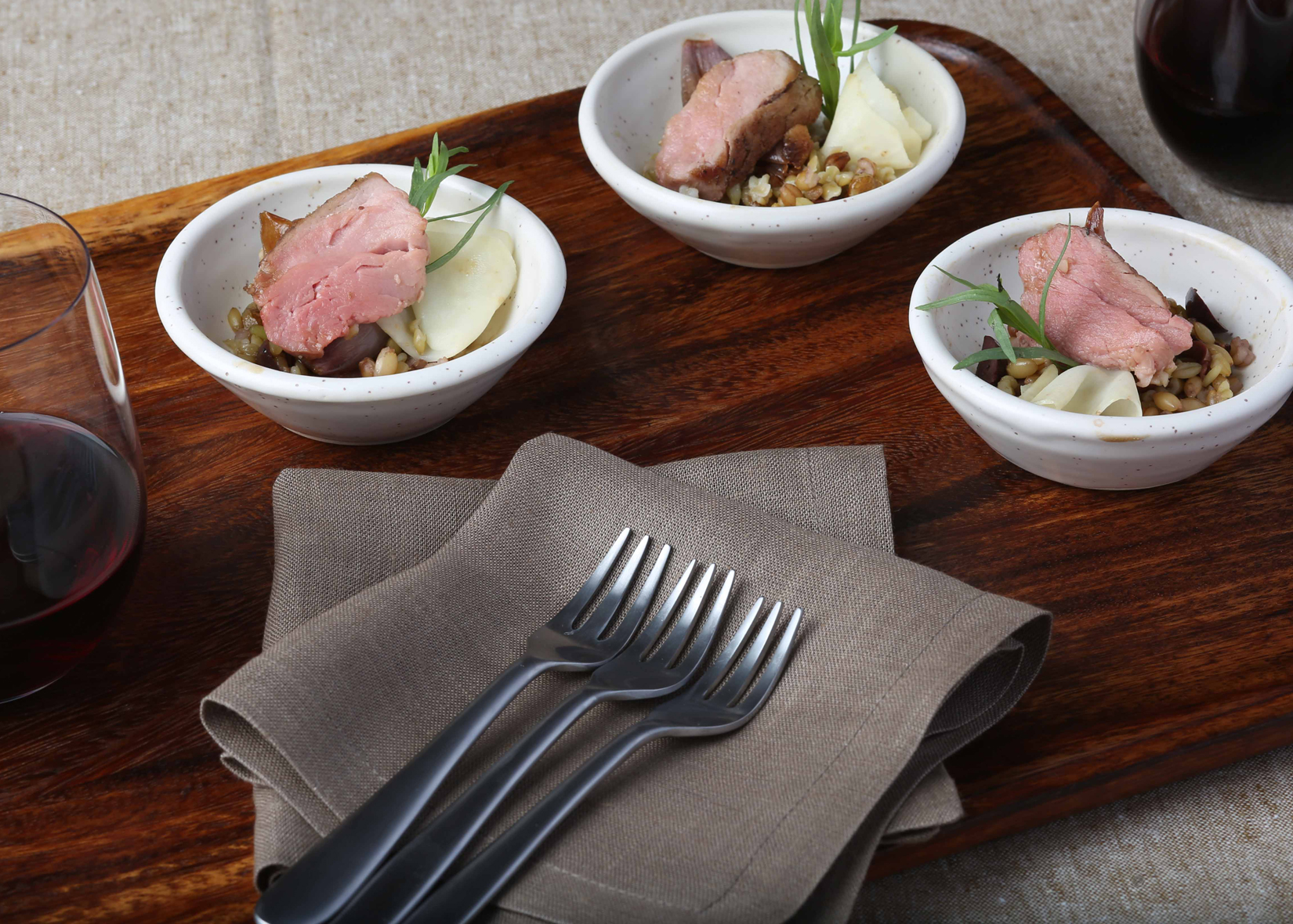 Roasted Veal, Farro and Black Truffle Vinaigrette on table satting