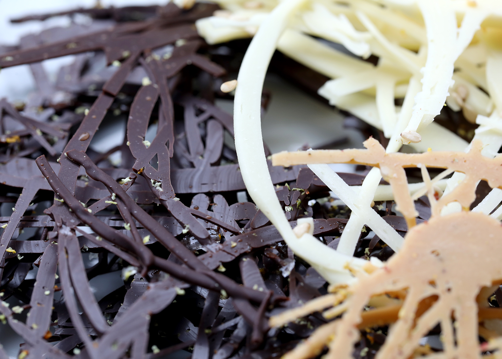 Decorative chocolate swirls that are used as a garnish for desserts