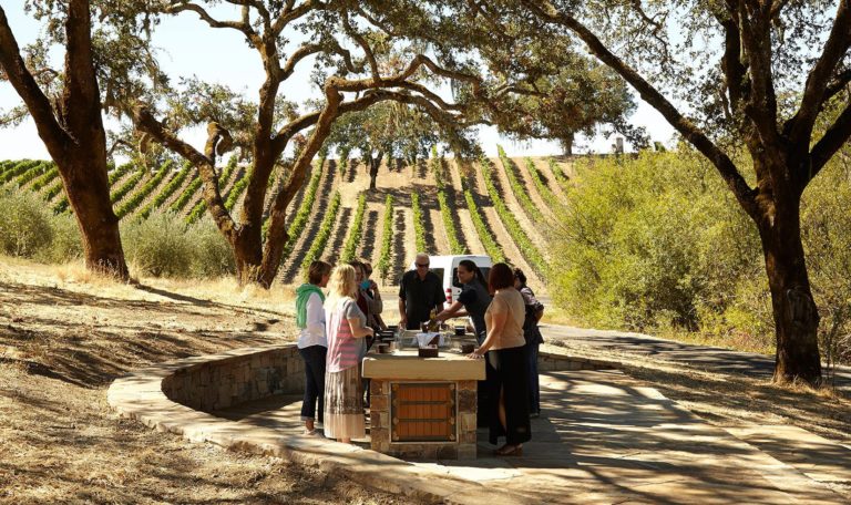 guests enjoying a pour of wine on a stop on The Estate Tour at Jordan Winery
