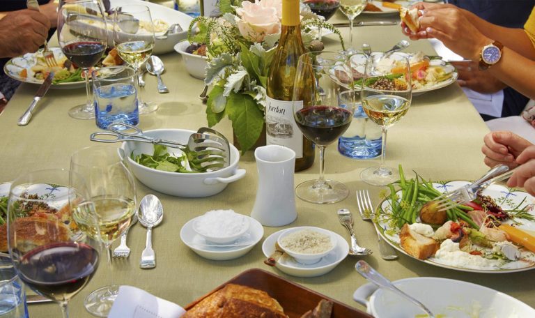 guests seated at a Jordan Winery harvest lunch with an assortment of food on their plates