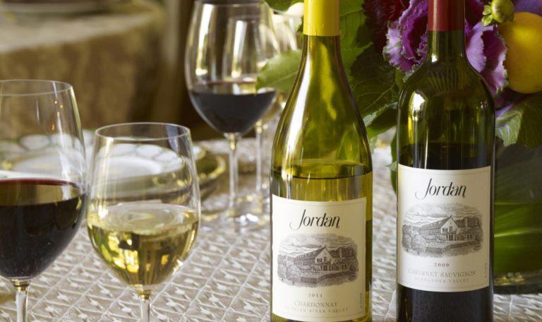 Bottles of 2011 Jordan Chardonnay and 2009 Jordan Cabernet Sauvignon at the dinner table.