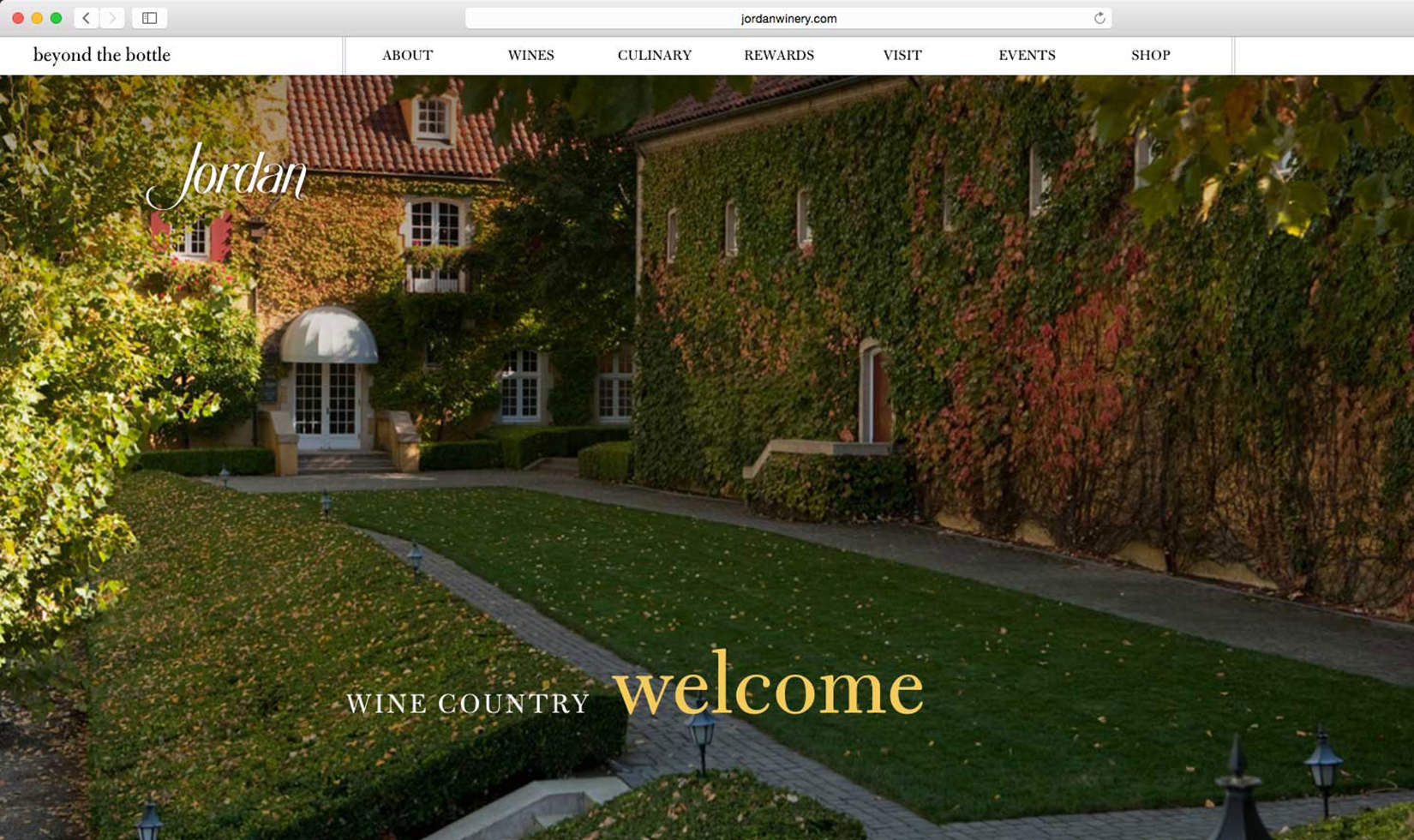 Entrance to Jordan Winery Chateau with fall colors with image text: "wine country welcome. Jordan"
