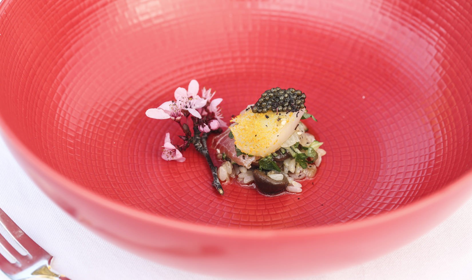 A close-up shot of the first course in a red bowl at the 2015 Valentine's Dinner at Jordan Winery.