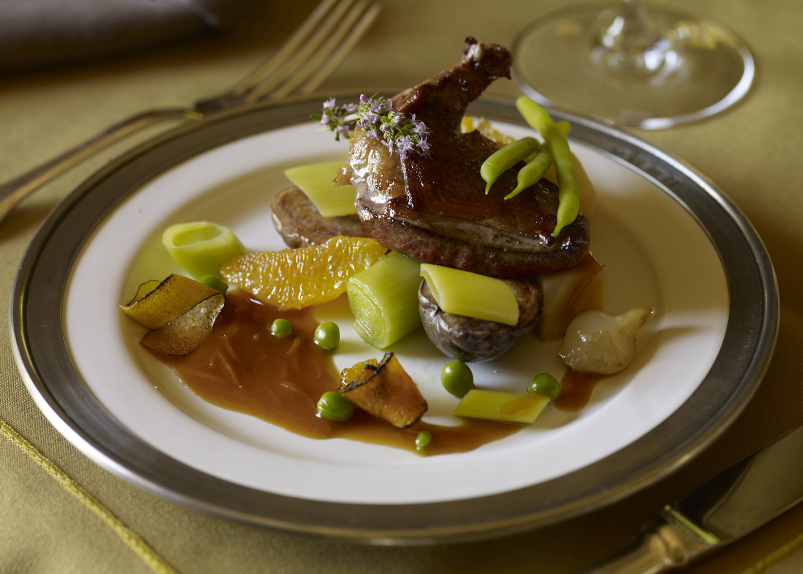 Roasted spiced squab with citrus on table setting