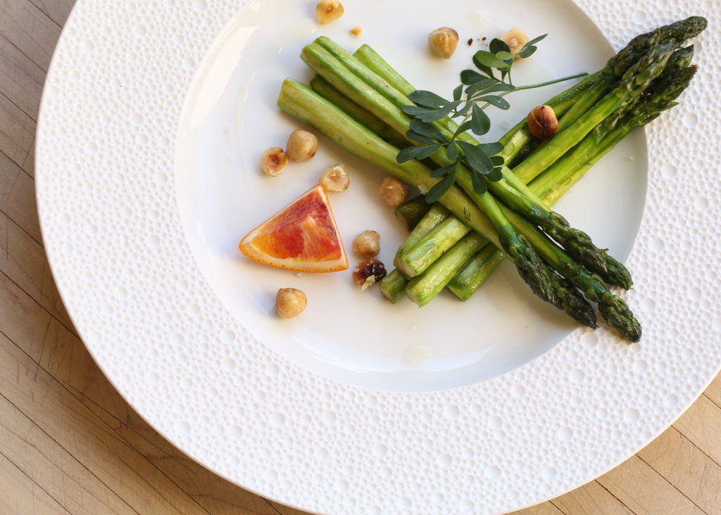 Grilled Asparagus, Blood Orange & Hazelnuts on white plate