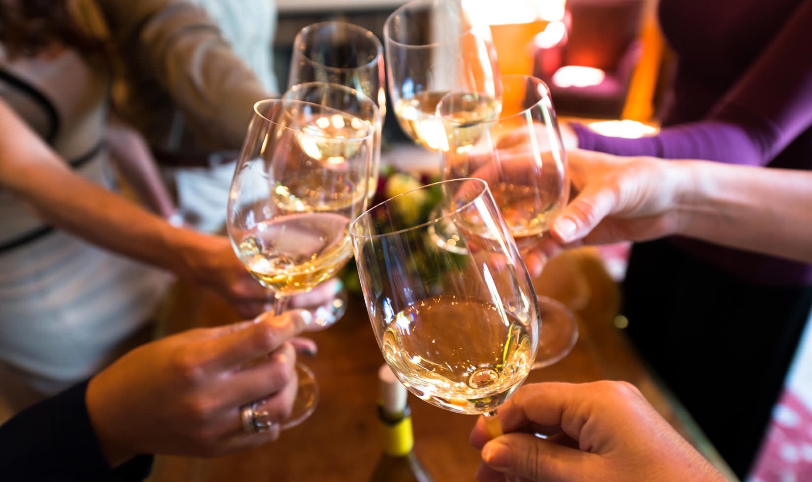 hands toasting with glasses of Jordan Winery Chardonnay