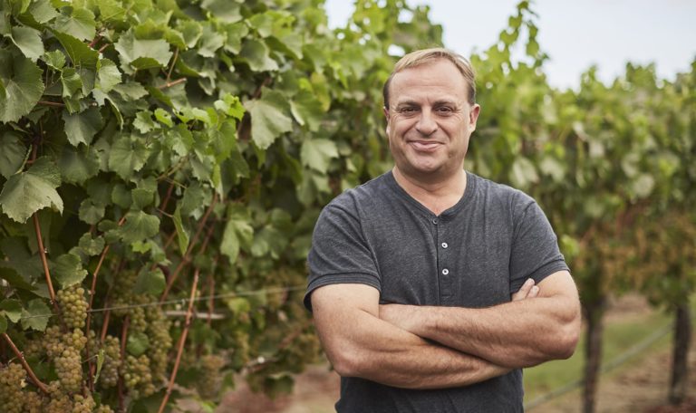 John Jordan, CEO and proprietor of Jordan Winery standing in a vineyard
