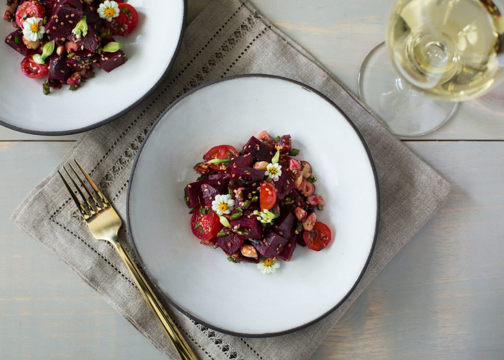 Vegetarian poke salad with beets and tomatoes on plate