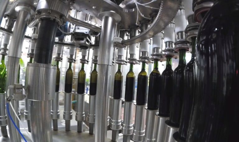 inside wine bottling line, wine being bottled