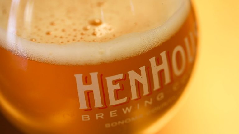 close up of beer in a HenHouse logo glass