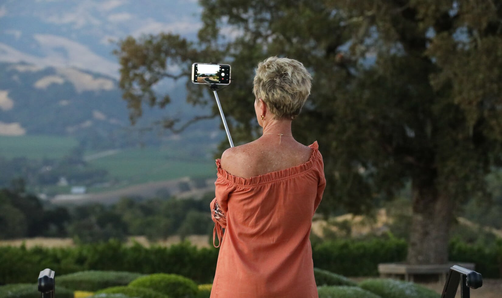 woman taking a picture with selfie stick at a Jordan Winery event