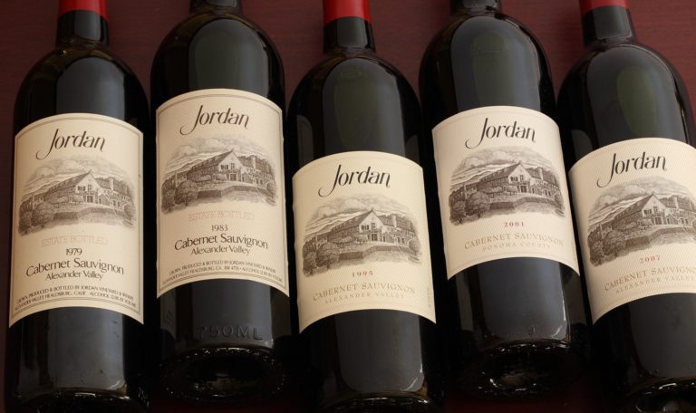 a bottle of 1979, 1983, 1995, 2001, and 2007 Jordan Winery Cabernet side by side