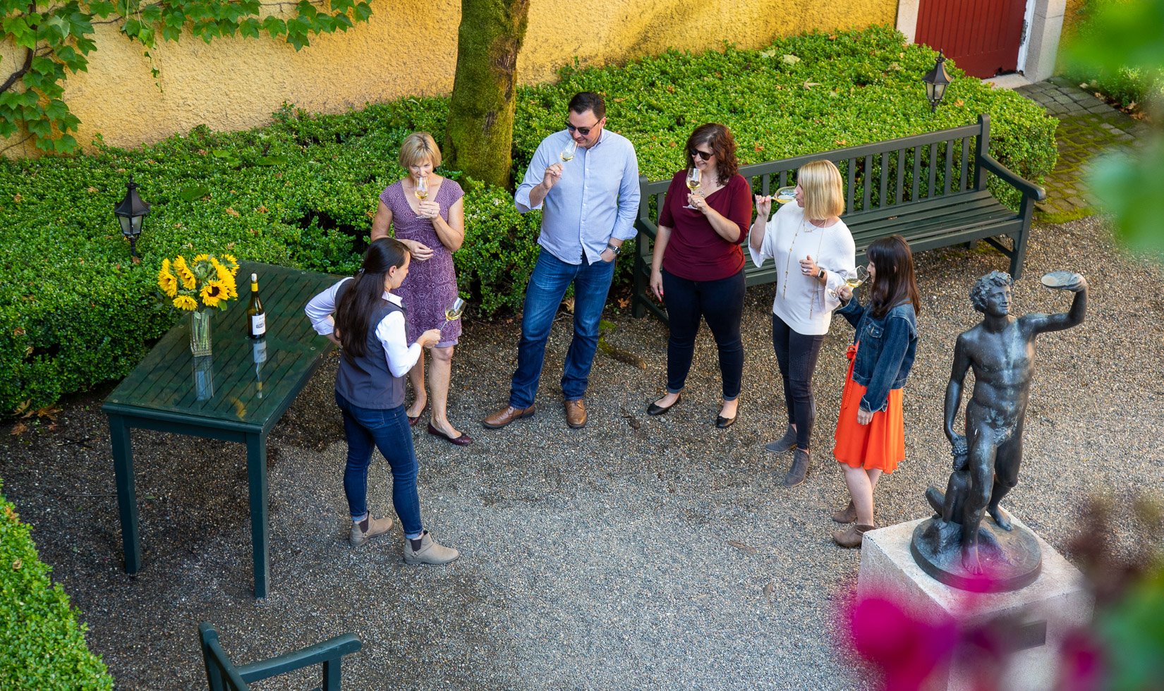 Group of people sipping chardonnay before winery tour begins