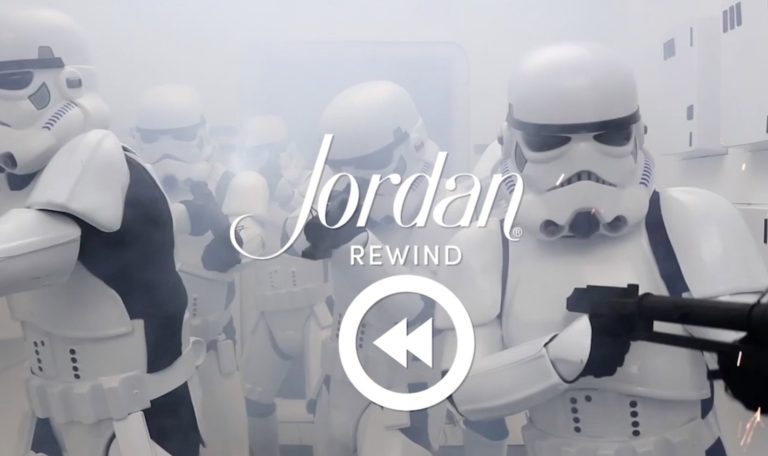 a still from a video made by Jordan Winery featuring a room full of people dressed as Storm Troopers with image text: "Jordan Rewind"