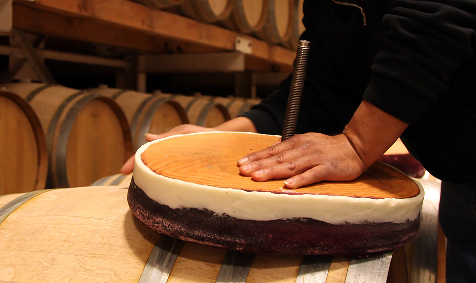 Jordan Winery cellar worker tallowing oak vat doors