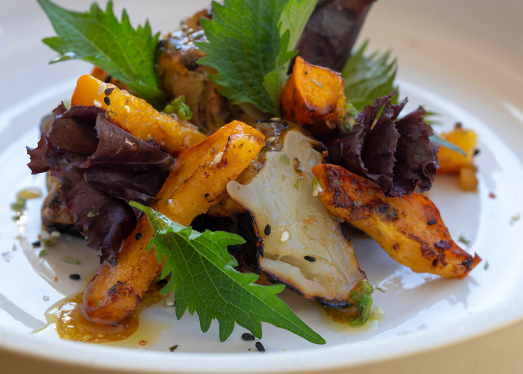 Grilled sunchoke salad with miso vinaigrette on plate