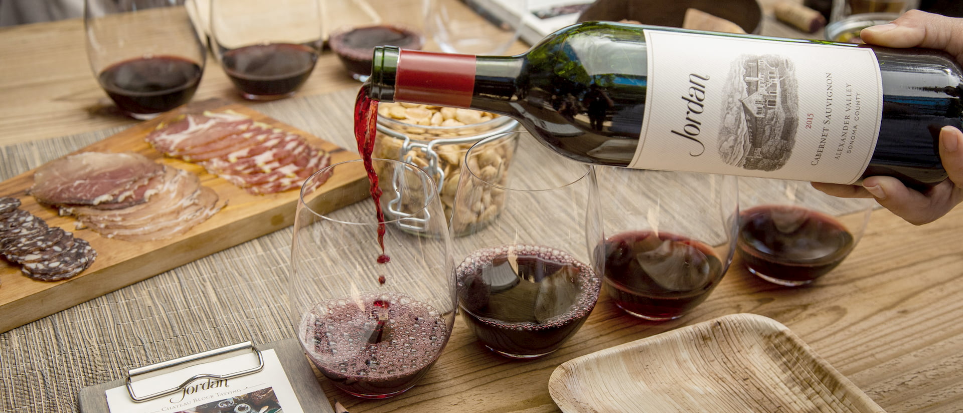 Jordan wine being poured into glasses on tableset