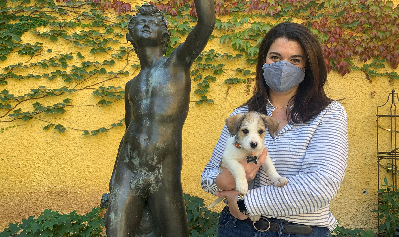 Jordan Winemaker Maggie Kruse holding new puppy in Bacchus Courtyard