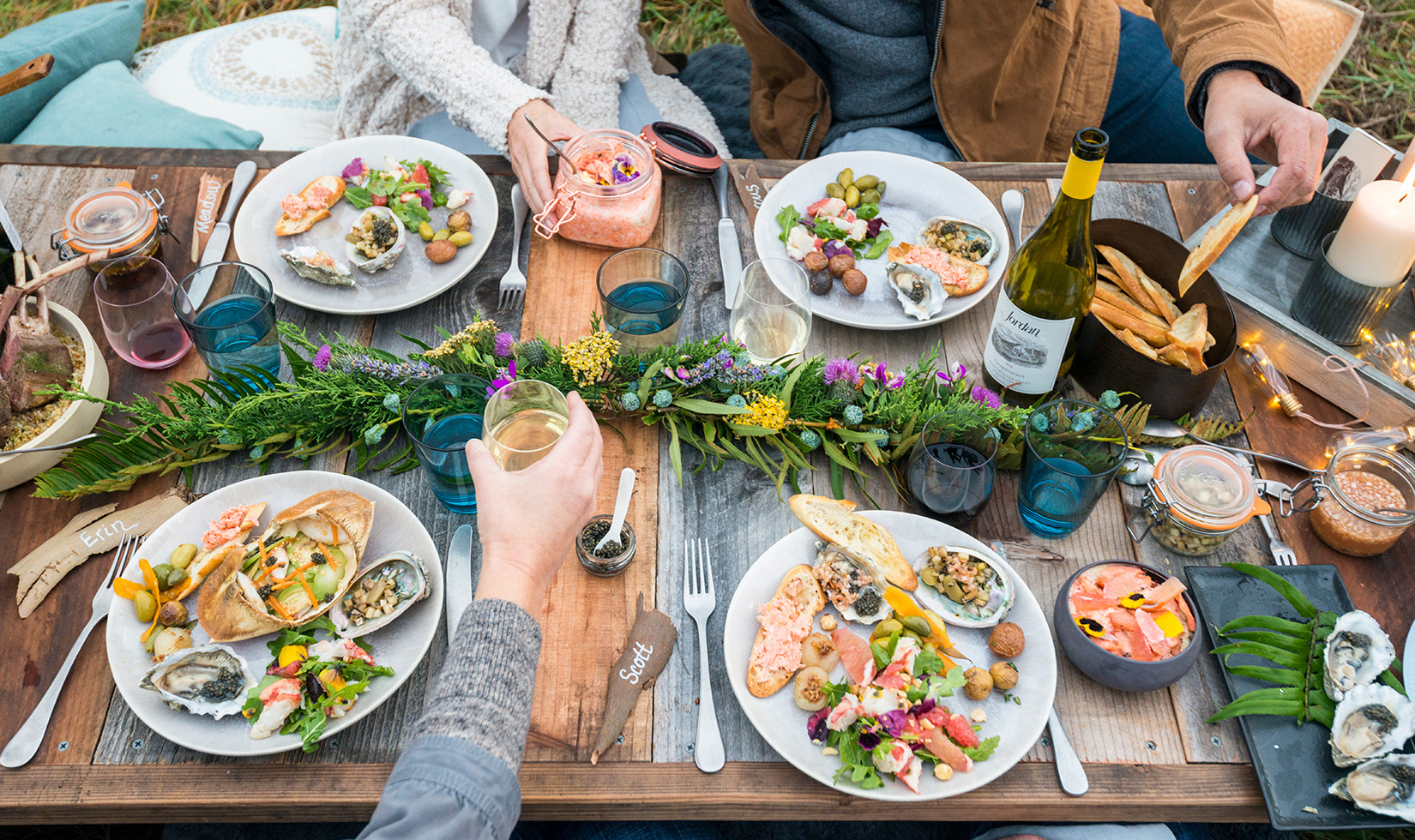 People enjoying food and Jordan wine during a picnic