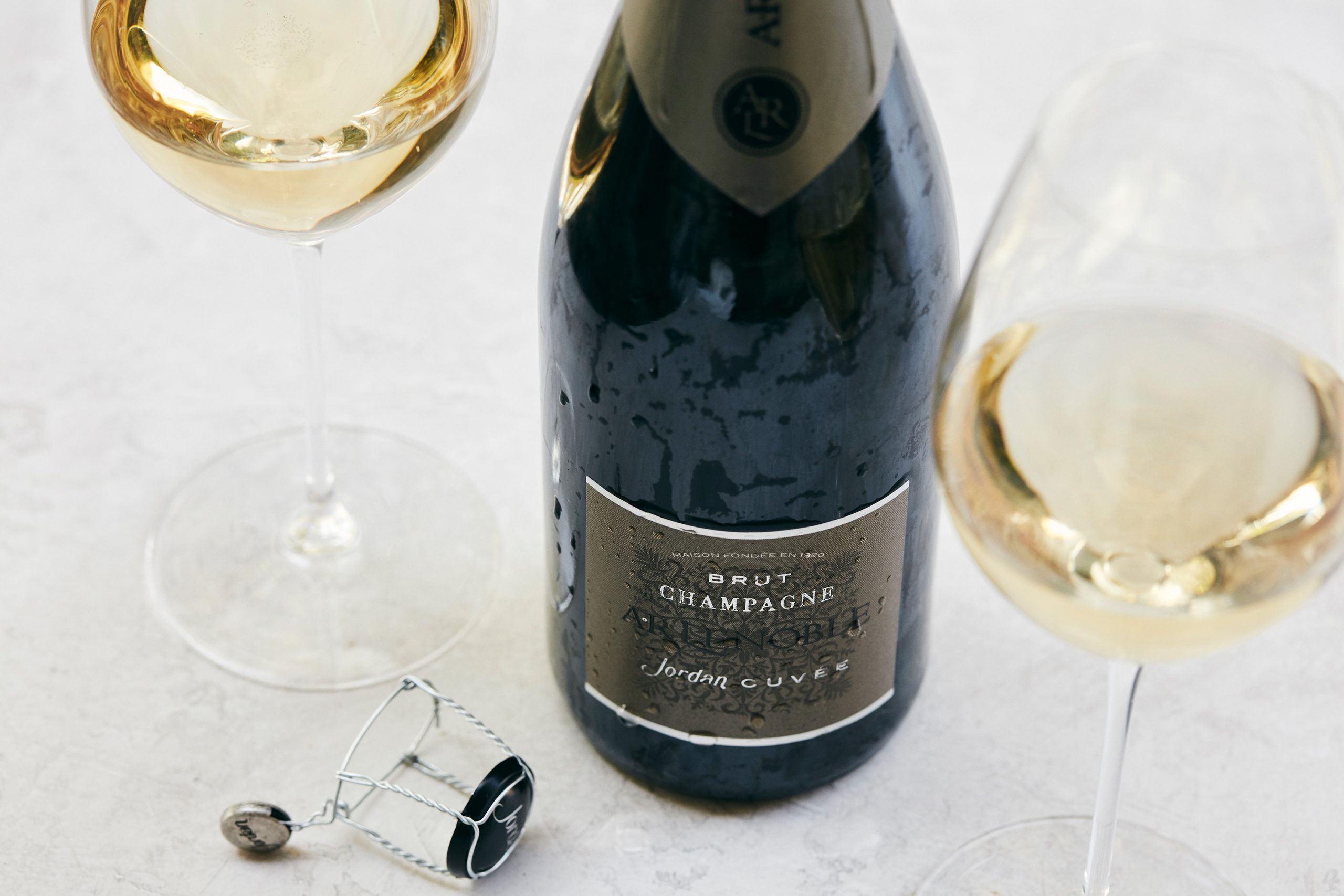 A bottle and glasses of Jordan Cuvee by Champagne AR Lenoble