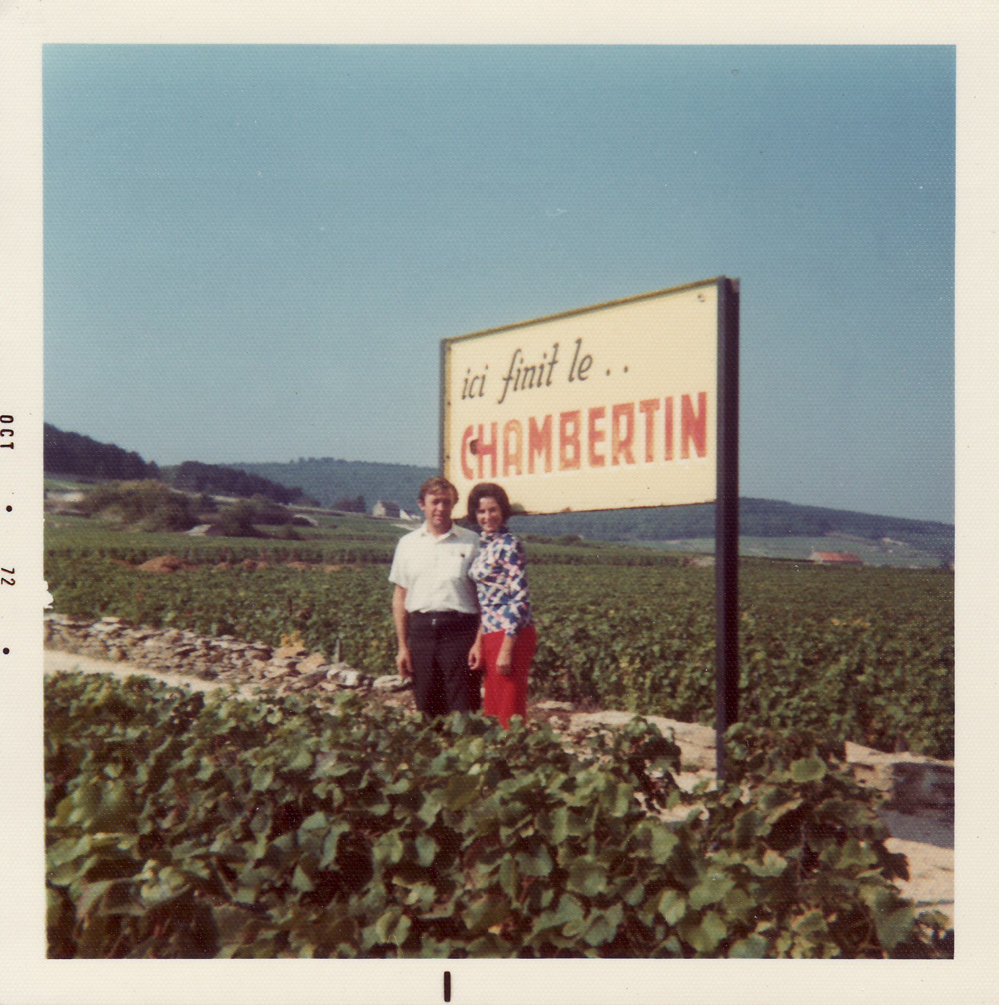 Tom and Sally Jordan standing in front of a sign that says CHAMBERTIN
