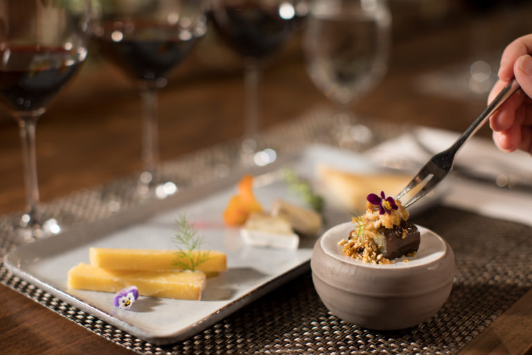 cabernet sauvignon with food pairing and cheese plate on wood table