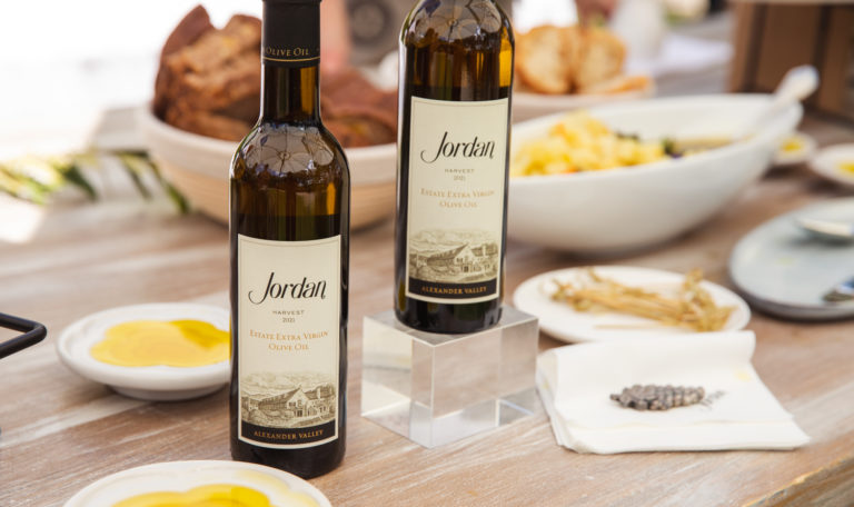 two olive oil bottles on table