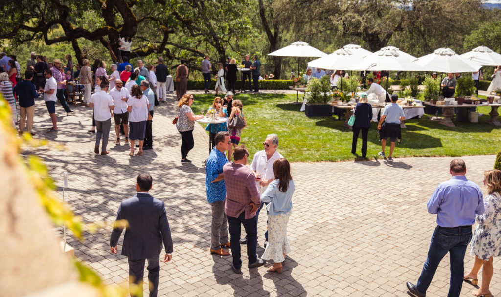 people standing and mingling on outdoor terrace