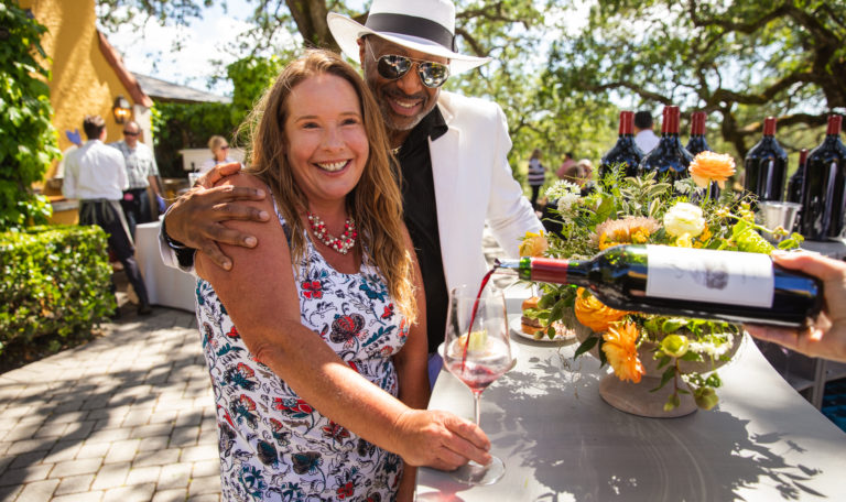 man and woman laughing with glass of cabernet wine