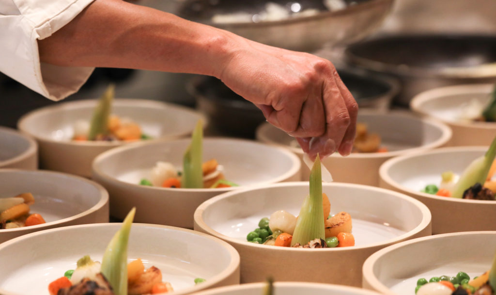 chef preparing formal dishes in kitchen