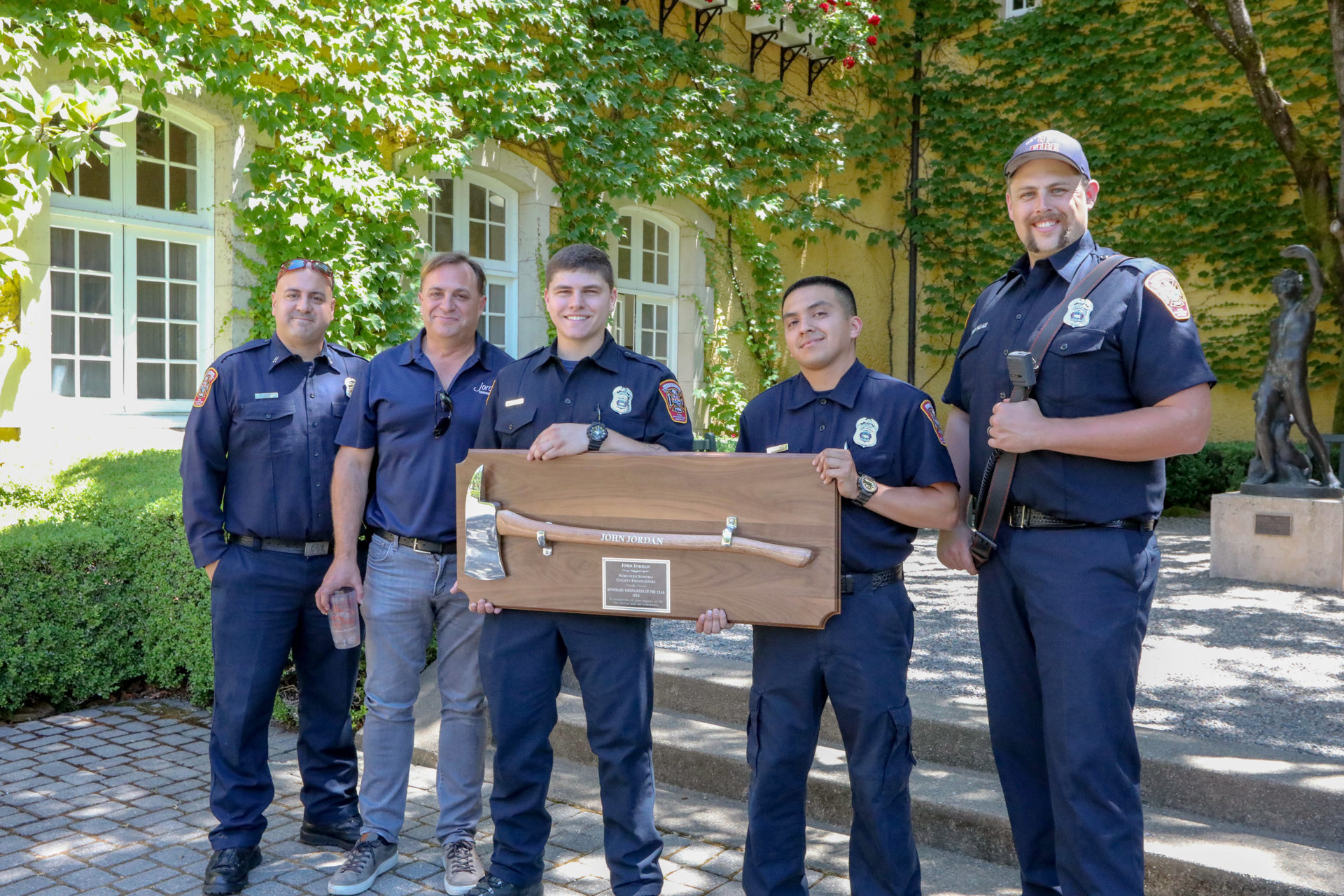 John Jordan, with a group of firefighters, receiving the Firefighter of the Year Award