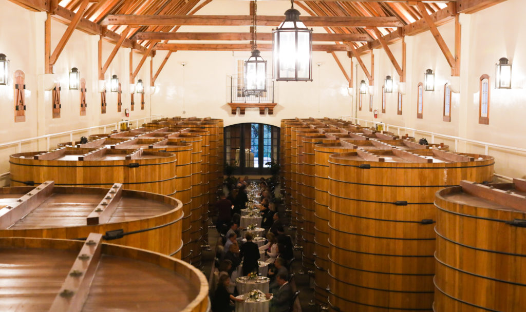 private tables in large wine cask room for formal dinner