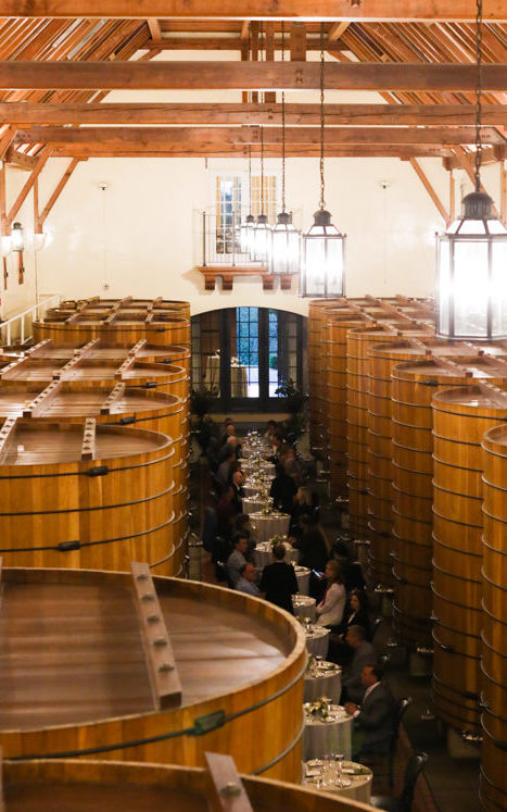 private tables in large wine cask room for formal dinner