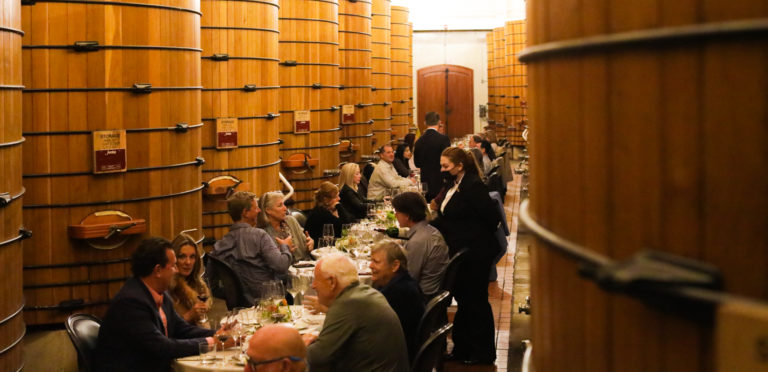 private tables in large wine cask room for formal dinner