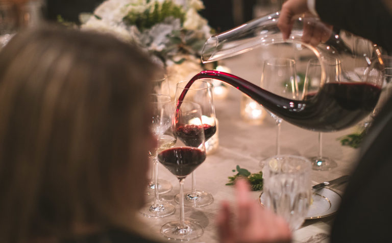 Person pouring Jordan Cabernet Sauvignon at a dining table