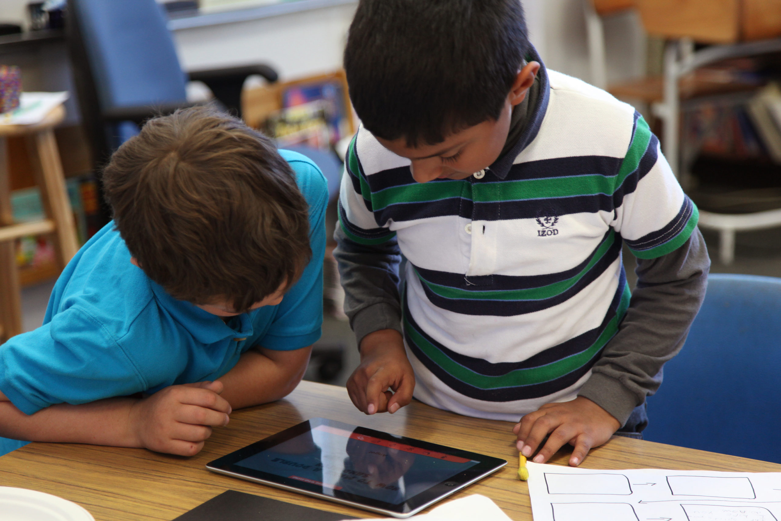 Two students using a tablet in the classroom