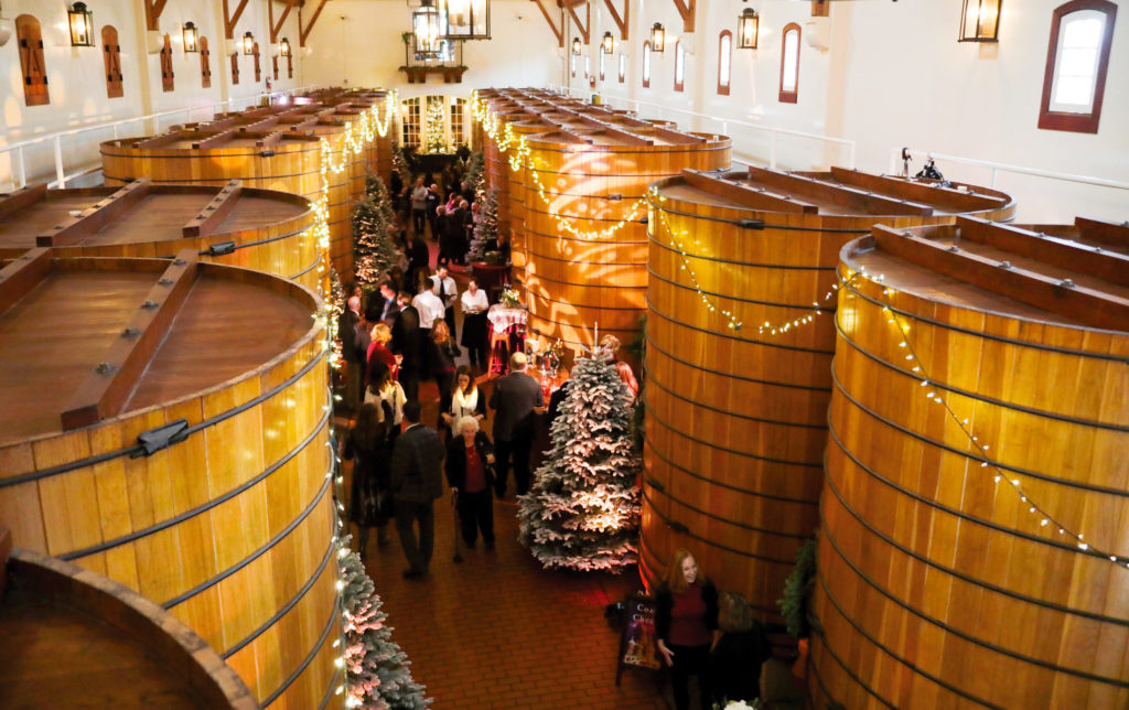 People inside the winery which is decorated for the holidays
