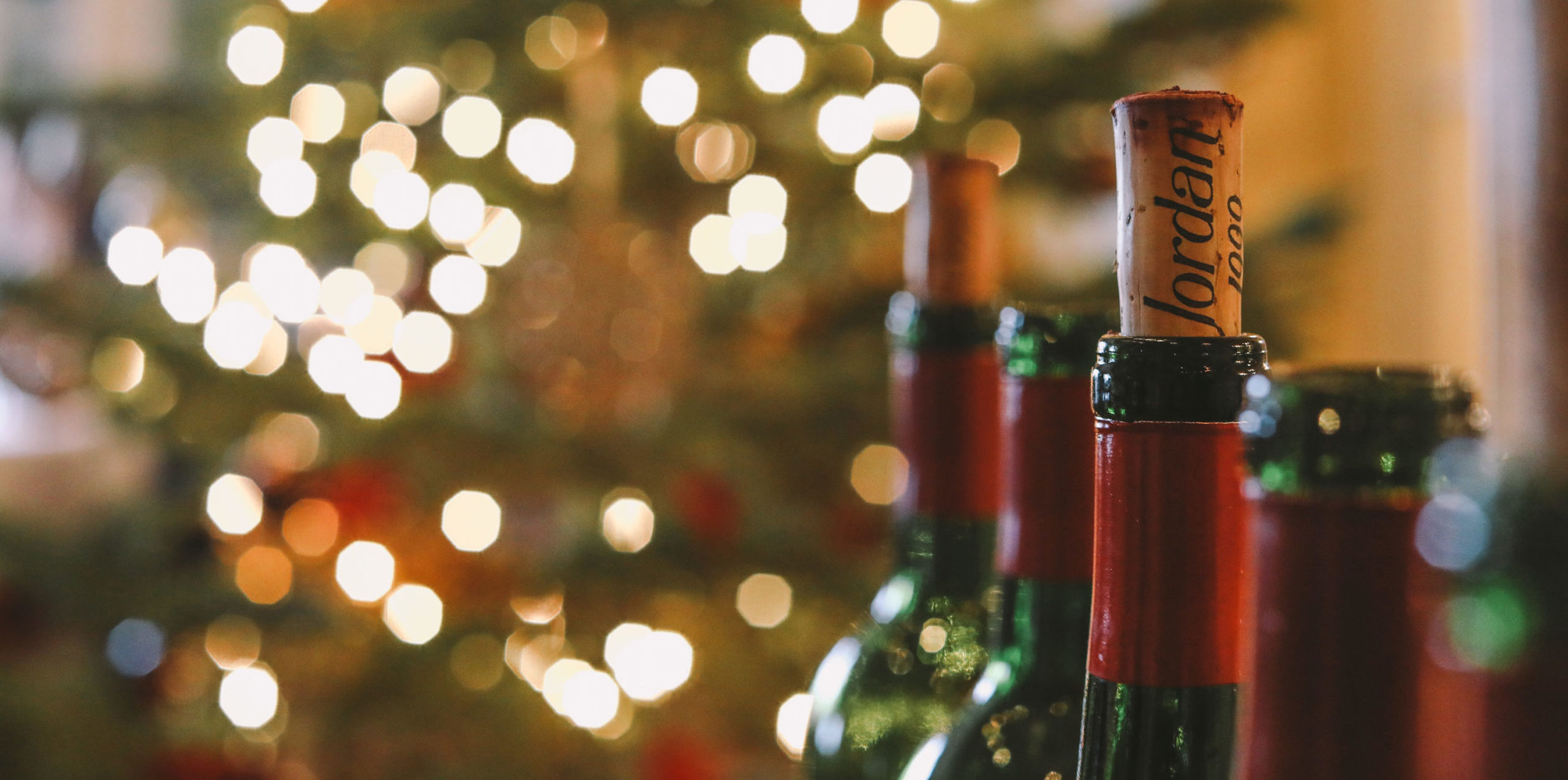 Bottles of Jordan Cabernet Sauvignon with holiday decorations in the background