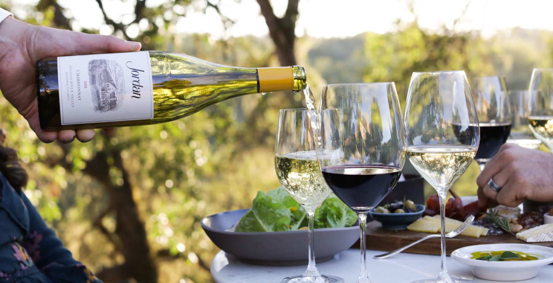 Jordan Chardonnay pouring into wine glass for outdoor lunch