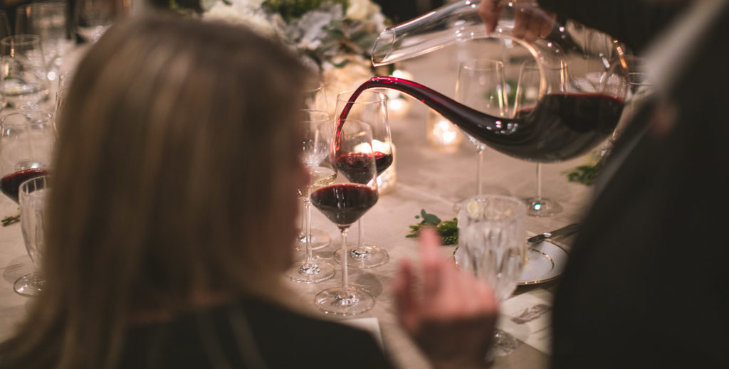 Person pouring Jordan Cabernet Sauvignon at a dining table