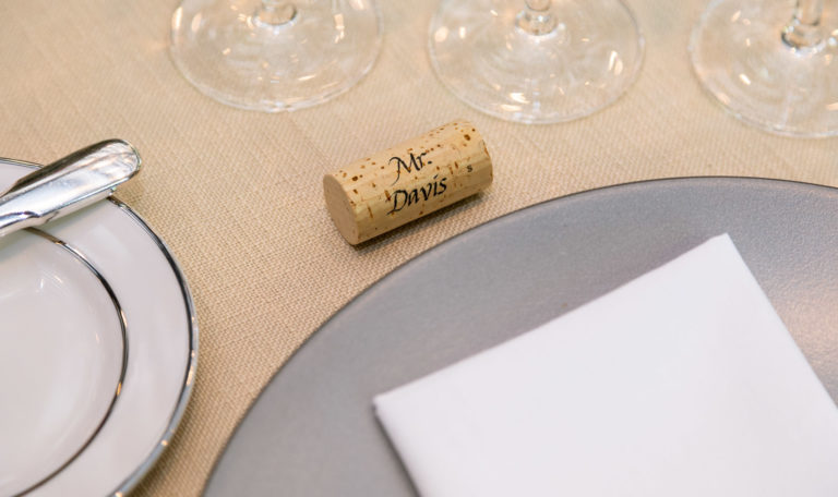Place setting with a cork that says Mr. Davis