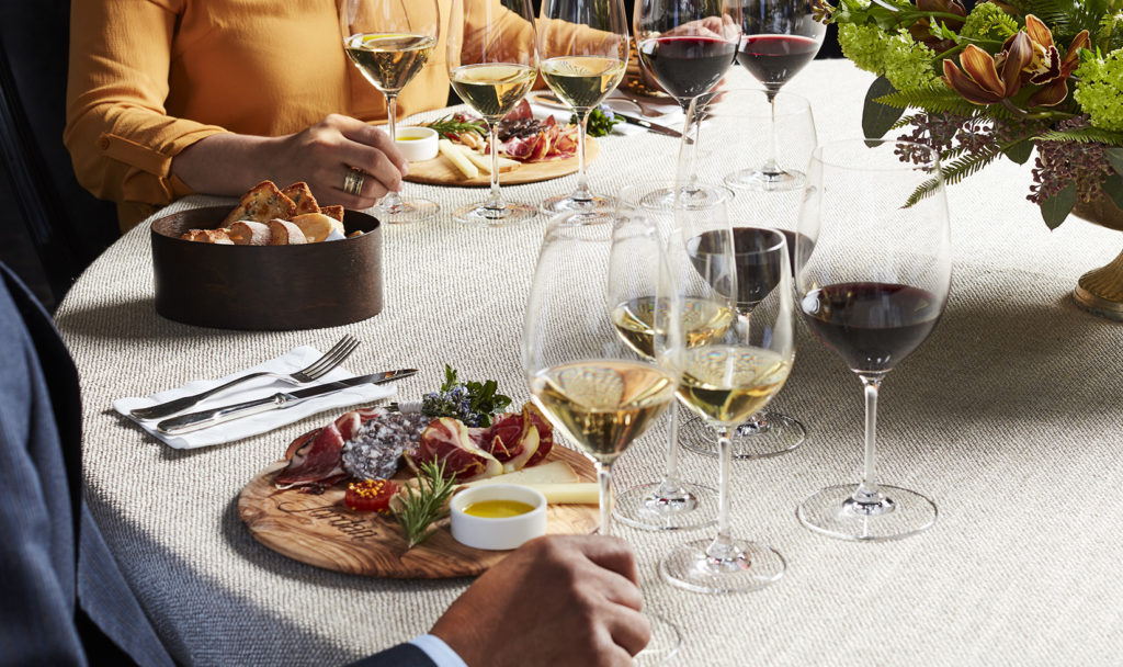 People enjoying artisanal salumi and cheeses paired Jordan Cabernet Sauvignon and Jordan Chardonnay at a table